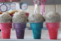 four ice cream cones with sprinkles on them