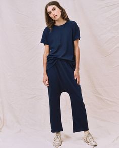 A look all its own, The Jersey Crop. is an elastic waist jersey pant with our signature dropped rise and a wider straight leg. The ultimate in casual, we love this pant with a tee and sandals. Handcrafted locally in Los Angeles, our process ensures beauty and uniqueness—no two pieces are alike. 100% Cotton Model is 5'9" wearing size 1 Size 1 - Inseam: 20 1/4" Rise: 16 5/8" Leg Opening: 8 3/4" Machine Wash Cold Tumble Dry Low Made in the U.S.A. Sporty Summer Pants For Everyday, Casual Summer Sweatpants For Everyday, Emily And Meritt, Jersey Pants, Two Pieces, Womens Tees, Elastic Waist, Straight Leg, Jumpsuit