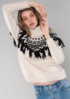 [Color: Ivory/Black] A cozy ski sweater with a bohemian twist. Featuring a warm turtleneck and a contrast knit yoke design and a fringed detail in front and back. Sweater With Fringe, Bohemian Winter Sweater With Tassels, Winter Knit Sweater With Tassels, Bohemian Knit Sweater With Fringe, Boho Fringe Sweater, White Fringed Sweater, Beige Long Sleeve Sweater With Fringe, Frindge Sweater, Sweater Refashion