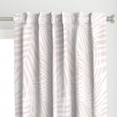 a curtain with a pink and white leaf pattern on it