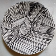 a black and white plate sitting on top of a table