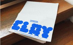 a white paper bag with blue mickey mouses on it sitting on a wooden table