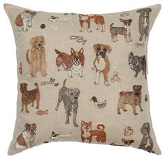 a pillow with dogs on it in various colors and sizes, sitting on a white surface