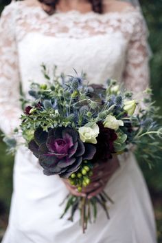 a bride holding a bouquet of flowers in her hands