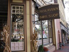 the storefront of morgan book shop with corn stalks on display