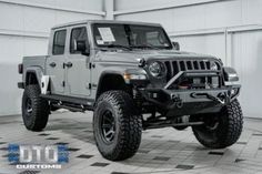 a gray jeep is parked in a garage