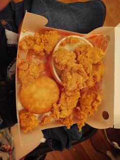 fried food in a box with dipping sauce