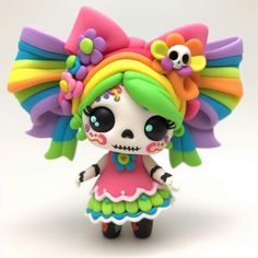 a small doll with colorful hair and flowers on it's head is standing in front of a white background