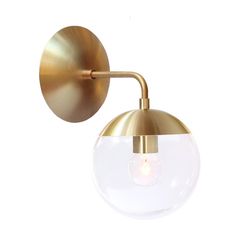 a brass wall light with a glass ball on the front and one light on the back