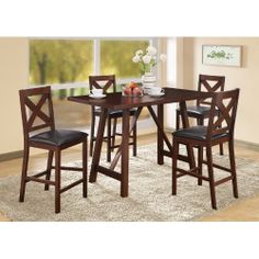 a dining room table with four chairs around it