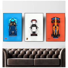 three framed photographs of race cars hanging on a wall above a brown couch in a living room