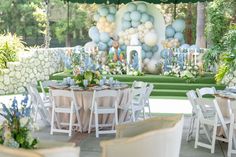 an outdoor event with tables and chairs set up for a formal function in the garden