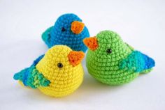 three small crocheted birds sitting next to each other