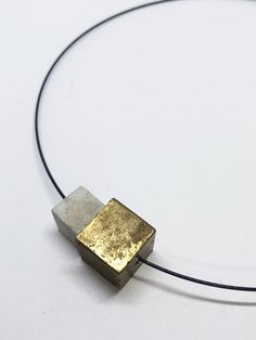 minimalist modern necklace in black stainless steel with 2 cubes of concrete. An element was processed with gold paint. All pieces of jewelery are designed and cast in our studio in the south of Hesse. The extra fine concrete is especially suitable for exclusive pieces of jewelry. The concrete pieces are processed in their natural state (unhoned and polished). Each chain is thus individual and unmistakable. Handmade in the style of CA.ON.IS. BAGS Choker circumference 40cm Lock for turning design & made in germany Concrete Minimalist, Gold Concrete, Choker Chain Necklace, Concrete Jewelry, Modern Necklace, Choker Chain, Modern Necklaces, Chain Choker Necklace, Black Stainless Steel