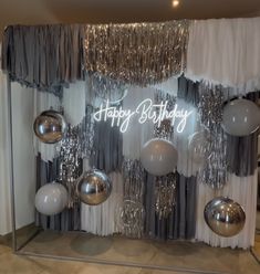 a happy birthday display with balloons and streamers