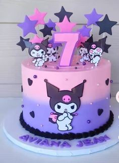 a pink and purple birthday cake with stars on the top that says seven years old