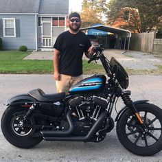 a man is standing next to his motorcycle