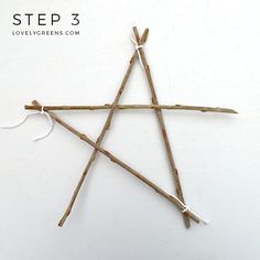 sticks are arranged in the shape of an inverted star with white string attached to them