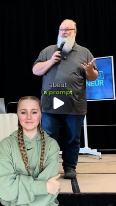 a woman with braids standing next to a man in front of a microphone on stage