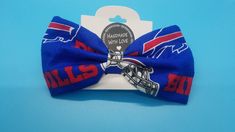 the buffalo bills bow tie is blue with red, white and blue letters on it