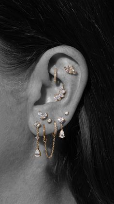 a woman's ear with three different types of piercings