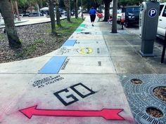 the sidewalk has been decorated with different designs on it and is lined with parking meters