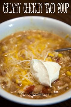 a bowl of creamy chicken taco soup with sour cream on top and the text overlay reads, creamy chicken taco soup