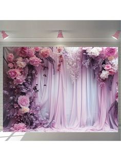 the backdrop is decorated with pink flowers and purple drapes for an elegant touch to the room