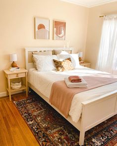 a white bed sitting on top of a wooden floor