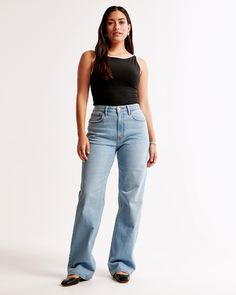 Our Curve Love relaxed jeans in a medium wash with a clean hem. This fit features a 10.5” high rise, is fitted at the waist and hips, and eases at the thigh into a relaxed, full-length leg shape. The viral fit that eliminates waist gap: Curve Love features additional room through the hip and thigh for curve-hugging comfort. This jean is made from our vintage stretch fabric which features both an authentic vintage look and contains slight built-in stretch for additional comfort. High Rise 90s Relaxed Jean, 90s Style Jeans, Female Features, Skort Dress, Abercrombie Jeans, Xmas List, Pant Trends, Skirt Trends, Unique Fits