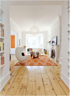 a living room filled with furniture and bookshelves next to a fire hydrant