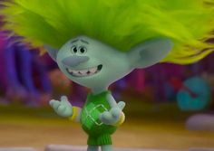 a cartoon character with yellow hair and green shirt