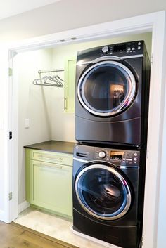 the washer and dryer are stacked on top of each other in this laundry room