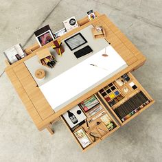 an overhead view of a desk with many items on it, including books and magazines