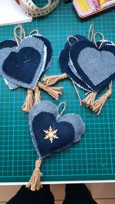 three heart shaped ornaments on a cutting board