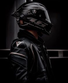 a man wearing a black leather jacket and helmet