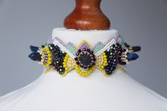 Colorful raw titanium choker necklace. Alternative wearable art jewelry gift for fashion lovers. Choker is adjustable on the back with volume of each neck. MADE TO ORDER - shades may differ slightly. Materials: Natural purple Titanium Crystal Agate. Purple glass crystals beads. Yellow glass beads. Pale purple seed beads. Pale green seed beads. Pale yellow seed beads. Neutral seed beads. Yellow seed beads. Purple seed beads. Vegan leather. Sterling silver claps. FREE SHIPPING. We offer fast shipp Unique Adjustable Choker With Unique Variations, Unique Adjustable Choker With Variations, Artistic Adjustable Choker Jewelry, Titanium Crystal, Crystals Beads, Mermaid Shell, Beadwork Designs, Wearable Art Jewelry, Pale Purple