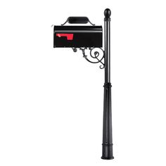 a black mailbox mounted to the side of a pole with a red light on it