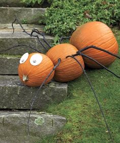 three pumpkins with googly eyes sitting on some steps