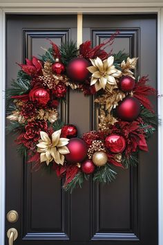 Festive holiday wreath with red and gold ornaments hanging on a black door. Wreaths For Front Door Diy Christmas, Reef Ideas Christmas, Christmas Wreaths Diy Ribbon, Red And Gold Wreath Christmas, Christmas Wreaths Tutorial, Diy Christmas Wreath Ornaments, Christmas Wreath Ideas 2024, Diy Christmas Door Wreaths, Easy Diy Christmas Wreath Ideas