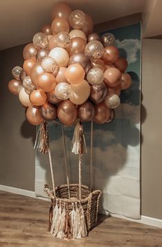 a bunch of balloons that are in the air with tassels on top of them