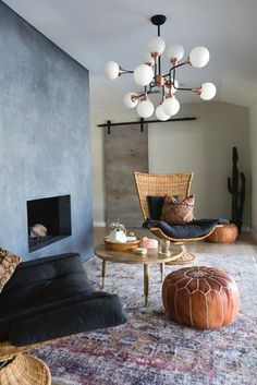 a living room filled with furniture and a fire place in the middle of the room