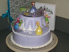 there is a large cake decorated with princess figurines