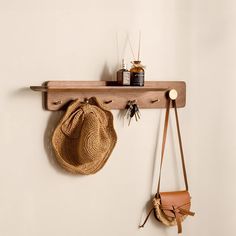 a hat and purse hanging on a wooden shelf