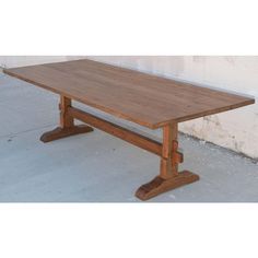 a wooden table sitting on top of a cement floor