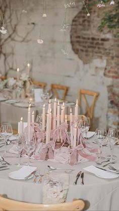 the table is set with candles and place settings