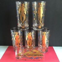 four glasses with gold seahorses on them