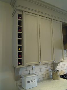 a kitchen with white cabinets and an oven