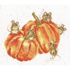 a cross stitch pattern with mice on pumpkins and one mouse sitting on top of the pumpkin