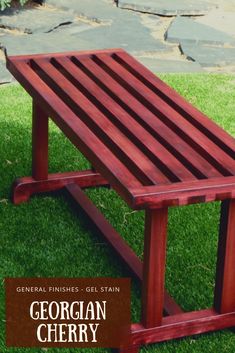 a wooden bench sitting on top of green grass